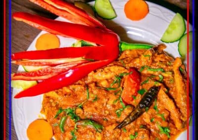 Curry dish presented with decorative chilli