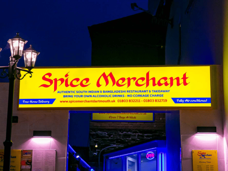 The Spice Merchant Indian cuisine restaurant front with a yellow and red sign